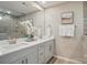Bathroom showcasing dual sinks, contemporary finishes, and a large frameless mirror at 9930 Cask Way, Huntersville, NC 28078