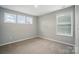 Bedroom featuring natural light from two windows and neutral carpet at 9930 Cask Way, Huntersville, NC 28078