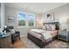 Inviting bedroom with natural light, a cozy armchair, and stylish decor creating a relaxing retreat at 9930 Cask Way, Huntersville, NC 28078