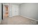 Empty bedroom has neutral carpet, double closet, and entrance to the ensuite bath and walk-in closet at 9930 Cask Way, Huntersville, NC 28078