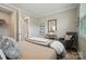 Cozy bedroom with neutral tones, a decorative chair, and ample closet space for a peaceful retreat at 9930 Cask Way, Huntersville, NC 28078