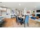 A dining room adjacent to living area showcasing seamless transition and modern decor at 9930 Cask Way, Huntersville, NC 28078