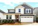 Inviting two-story home with grey and white siding, a two-car garage, and a well-maintained front yard at 9930 Cask Way, Huntersville, NC 28078