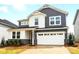 Attractive two-story home featuring mixed siding, a two-car garage, and manicured landscaping at 9930 Cask Way, Huntersville, NC 28078