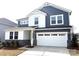 Exterior elevation shows a lovely home with a two-car garage and stone accents at 9930 Cask Way, Huntersville, NC 28078