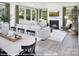 Sunlit living room features a fireplace, modern furnishings, and large windows with green views at 9930 Cask Way, Huntersville, NC 28078