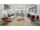 Bright living room features neutral tones, modern decor, comfortable seating, and plenty of natural light at 9930 Cask Way, Huntersville, NC 28078