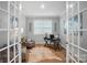 Home office with French doors, a cowhide rug, and ample natural light for a productive workspace at 9930 Cask Way, Huntersville, NC 28078