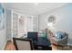 Home office with glass doors leading to a hallway, furnished with chairs, rug, and a modern workspace at 9930 Cask Way, Huntersville, NC 28078