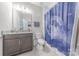 Neutral toned bathroom featuring vanity with stone countertops and a blue, moon-themed shower curtain at 1048 Harbor Bay Dr, Indian Land, SC 29707