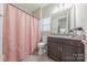 Bathroom with modern vanity, granite countertop, and a bathtub with shower curtain at 1048 Harbor Bay Dr, Indian Land, SC 29707