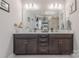 Bathroom featuring a double vanity with modern fixtures, spacious cabinets, and decorative wall art at 1048 Harbor Bay Dr, Indian Land, SC 29707