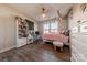 Bright bedroom with unique decor, large windows, and hardwood floors creating a cozy living space at 1048 Harbor Bay Dr, Indian Land, SC 29707