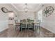 Elegant dining room features a wooden table with stylish chairs, decorative lighting, and tray ceiling at 1048 Harbor Bay Dr, Indian Land, SC 29707