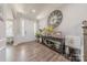 Bright foyer with a large clock, hardwood floors, and a glimpse into the home's layout at 1048 Harbor Bay Dr, Indian Land, SC 29707