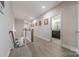 Upstairs hallway with hardwood floors leading to an open bathroom at 1048 Harbor Bay Dr, Indian Land, SC 29707