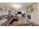 Inviting living room featuring a fireplace, large leather sectional, and staircase at 1048 Harbor Bay Dr, Indian Land, SC 29707