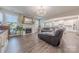 Living room features a fireplace, a large leather sectional, and great natural light at 1048 Harbor Bay Dr, Indian Land, SC 29707