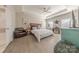 Spacious main bedroom featuring a tray ceiling, hardwood floors, and a private ensuite bathroom at 1048 Harbor Bay Dr, Indian Land, SC 29707