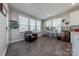 Bright sitting area with a leather chair, desk, and ample natural light from multiple windows at 1048 Harbor Bay Dr, Indian Land, SC 29707