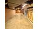 Unfinished basement, painted cinderblock walls, concrete floor, exposed HVAC ducts, lighting, and staircase at 1060 Laurel Ln, Gastonia, NC 28054