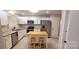 Modern kitchen featuring white cabinets, stainless steel appliances, and a functional center island at 1060 Laurel Ln, Gastonia, NC 28054