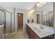 Bright bathroom featuring double sinks, a large mirror, and a glass-enclosed shower, for a functional space at 1100 Wallace Lake Rd, Fort Mill, SC 29707