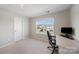 Bright bedroom with a large window and desk, offering a simple and functional area at 1100 Wallace Lake Rd, Fort Mill, SC 29707