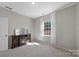 Bedroom with cozy fireplace, bright window with sheer curtains, and neutral walls and carpeting at 1100 Wallace Lake Rd, Fort Mill, SC 29707