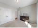 Cozy bedroom with neutral walls, carpet, closet, and fireplace, creating a warm and inviting space at 1100 Wallace Lake Rd, Fort Mill, SC 29707