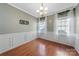 Dining room with hardwood floors, wainscoting, decorative chandelier, and natural light at 1100 Wallace Lake Rd, Fort Mill, SC 29707