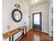 Stylish entryway featuring hardwood floors, decorative mirror, and a modern console table at 1100 Wallace Lake Rd, Fort Mill, SC 29707