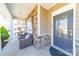 Inviting front porch with stone accents, seating area, and a decorative front door at 1100 Wallace Lake Rd, Fort Mill, SC 29707