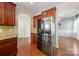 Well-lit kitchen featuring stainless steel refrigerator and wood cabinets for ample storage at 1100 Wallace Lake Rd, Fort Mill, SC 29707