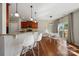 Kitchen and dining area with breakfast bar, stainless appliances, and modern lighting at 1100 Wallace Lake Rd, Fort Mill, SC 29707