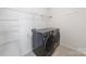 Functional laundry room with modern washer and dryer units and storage shelving at 1100 Wallace Lake Rd, Fort Mill, SC 29707