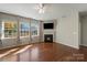 Bright open living room with hardwood floors, large windows, fireplace, and neutral colors at 1100 Wallace Lake Rd, Fort Mill, SC 29707