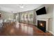 Bright open living room with hardwood floors, large windows, fireplace, and neutral colors at 1100 Wallace Lake Rd, Fort Mill, SC 29707