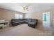 An expansive living room area with carpet flooring featuring a comfortable sectional sofa and ceiling fan at 1100 Wallace Lake Rd, Fort Mill, SC 29707