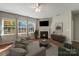 Cozy living room features a corner fireplace, plush seating, and sun-filled windows at 1100 Wallace Lake Rd, Fort Mill, SC 29707