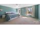 Spacious main bedroom with a ceiling fan, two windows, and light blue walls at 1100 Wallace Lake Rd, Fort Mill, SC 29707