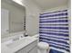 Bathroom showcasing a white vanity, framed mirror, and blue striped shower curtain at 11017 Woodland Creek Way, Charlotte, NC 28262