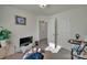 Bedroom featuring neutral colors, plants, television, and white closet doors at 11017 Woodland Creek Way, Charlotte, NC 28262