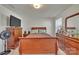 Bedroom with a wooden bed frame, matching dressers, and a TV for relaxing at 11017 Woodland Creek Way, Charlotte, NC 28262