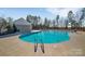 A spacious community pool is surrounded by trees, providing a refreshing amenity for residents at 11017 Woodland Creek Way, Charlotte, NC 28262