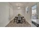 Simple dining area featuring table with gray cushions and a modern chandelier at 11017 Woodland Creek Way, Charlotte, NC 28262