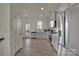 A kitchen featuring stainless steel appliances, light gray cabinetry and wood look flooring at 11017 Woodland Creek Way, Charlotte, NC 28262