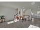 Spacious living room with wood flooring and staircase, bathed in natural light at 11017 Woodland Creek Way, Charlotte, NC 28262