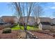 View of a backyard with green grass, a utility shed, landscaping, and the rear of the house at 114 Runningdeer Dr, Mooresville, NC 28117