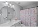 Renovated bathroom showcasing updated vanity, round mirror, and stylish shower curtain at 114 Runningdeer Dr, Mooresville, NC 28117